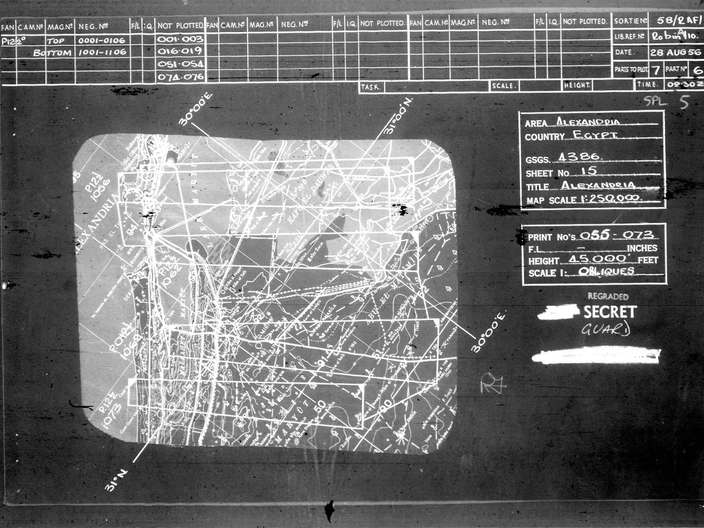 A crop taken from a roll of microfilm. At the top is a grid with details about the plotting of frames from a reconnaissance flight. To the right are more details about the flight and its location: Alexandria, Egypt. An excerpt from a map of Egypt occupies most of the centre of the image, with lines indicating where the aircraft took images.